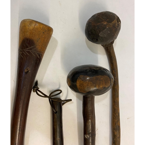 669 - FOUR SIMILAR ZULU KNOB KERRY TYPE WEAPONS. Each with rounded ends and tapering shafts, one with text... 