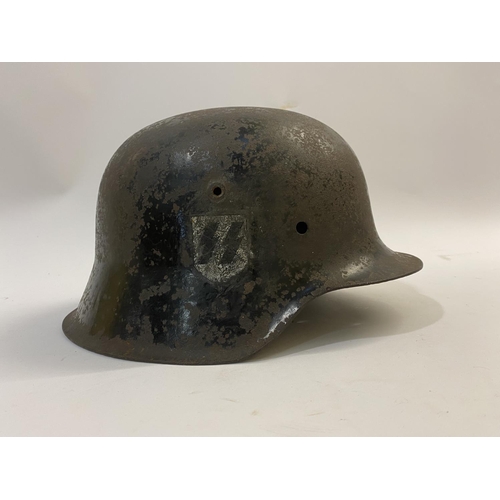 682 - A BLACK WAFFEN SS SINGLE DECAL M40 HELMET. A Second World War or later M40 type helmet shell, with w... 