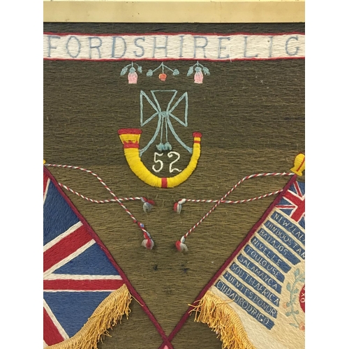 688 - A VICTORIAN OXFORD LIGHT INFANTEY WOOLWORK PANEL. A woolwork panel with banner '2nd Batt Oxfordshire... 