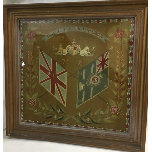 692 - A VICTORIAN WOOL WORK REGIMENTAL CREST THE 'KINGS' REGIMENT. A finely worked wool work picture of cr... 