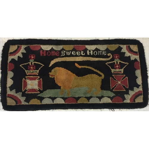 693 - A NAIVE HAND-KNOTTED REGIMENTAL RUG. A rectangular hand knotted woolen rug worked with the motto 'Ho... 