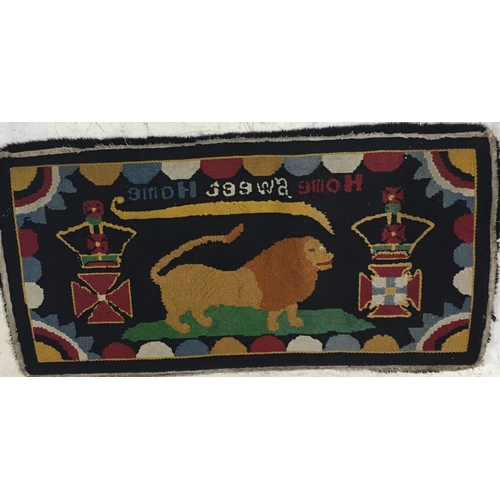 693 - A NAIVE HAND-KNOTTED REGIMENTAL RUG. A rectangular hand knotted woolen rug worked with the motto 'Ho... 