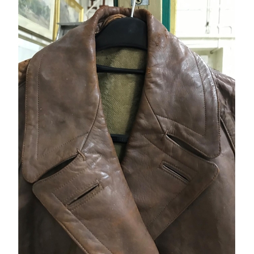 699 - AN EARLY 20TH CENTURY BROWN LEATHER FLYING JACKET AND BELT. A full length brown leather flying jacke... 