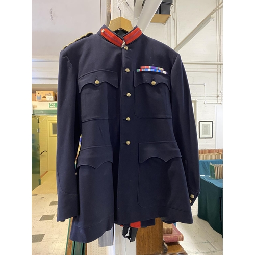 703 - AN OFFICERS NO1 DRESS UNIFORM BY HAMKES AND CO. A dress uniform, dark blue with red stripe to the tr... 