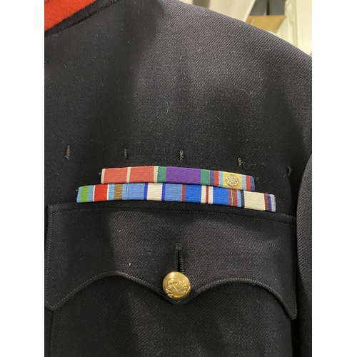 703 - AN OFFICERS NO1 DRESS UNIFORM BY HAMKES AND CO. A dress uniform, dark blue with red stripe to the tr... 