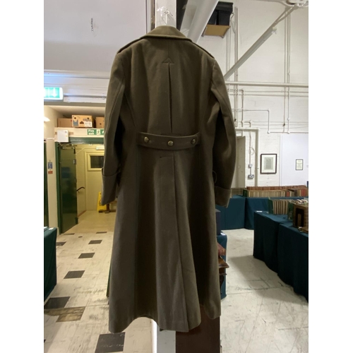 704 - AN ARMY OFFICERS GREAT COAT. A heavy khaki Great Coat with Royal Artillery buttons, the cannon benea... 