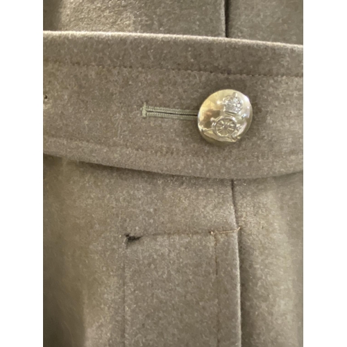 704 - AN ARMY OFFICERS GREAT COAT. A heavy khaki Great Coat with Royal Artillery buttons, the cannon benea... 