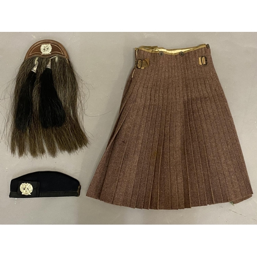 705 - A LONDON SCOTTISH SPORRAN, KILT AND GLENGARRY. A brown leather and horse hair sporran with twin tass... 