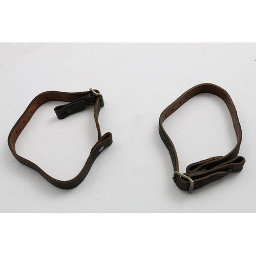 706 - TWO GERMAN HELMET CHIN STRAPS, ONE WITH SS MARKINGS. A leather chin strap with buckle and fixings at... 