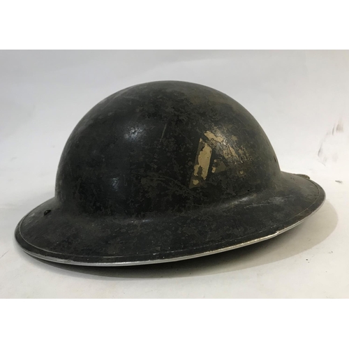 708 - AN EARLY SECOND WORLD WAR BRODIE TYPE HELMET AND TWO OTHERS. A Brodie type helmet stamped to the und... 