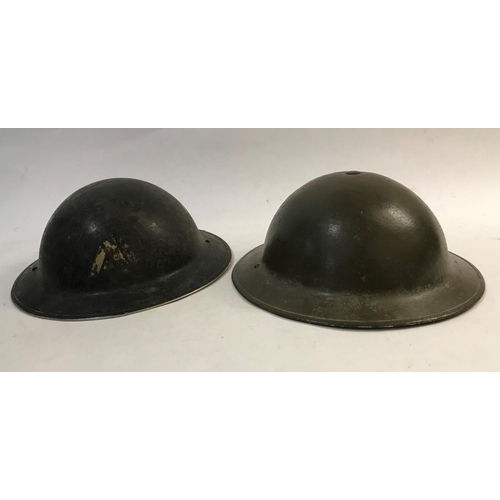 708 - AN EARLY SECOND WORLD WAR BRODIE TYPE HELMET AND TWO OTHERS. A Brodie type helmet stamped to the und... 