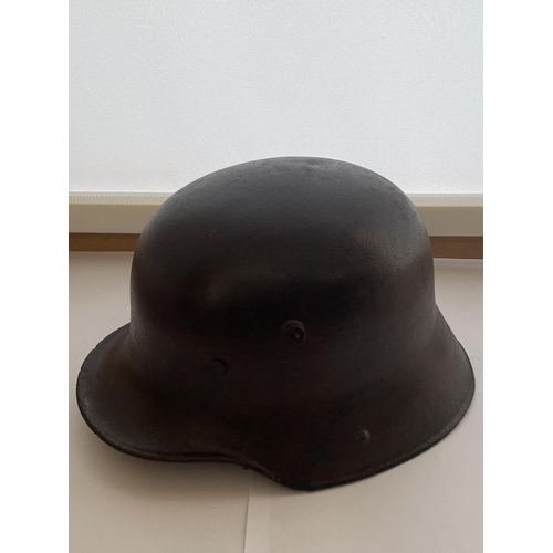 712 - A FIRST WORLD WAR GERMAN M16 STEEL HELMET. In excavated condition with twin lug vents and modern lea... 