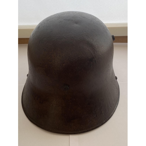 712 - A FIRST WORLD WAR GERMAN M16 STEEL HELMET. In excavated condition with twin lug vents and modern lea... 