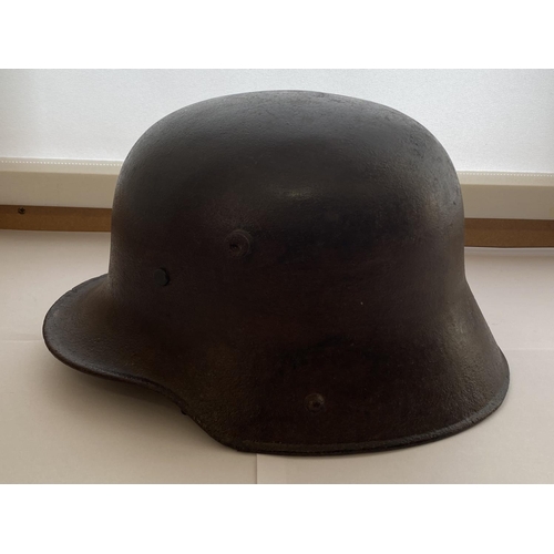 712 - A FIRST WORLD WAR GERMAN M16 STEEL HELMET. In excavated condition with twin lug vents and modern lea... 