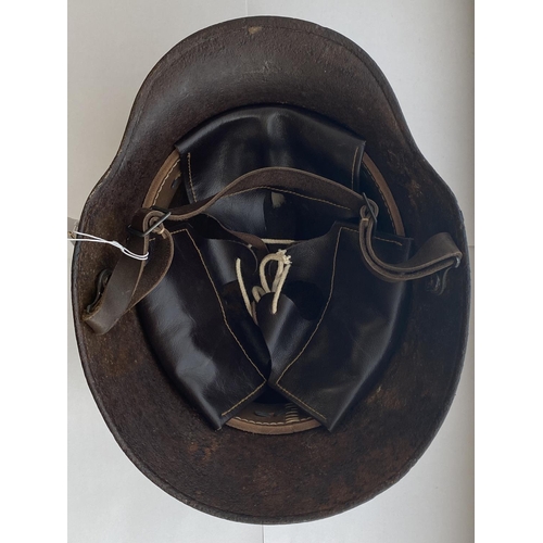 712 - A FIRST WORLD WAR GERMAN M16 STEEL HELMET. In excavated condition with twin lug vents and modern lea... 