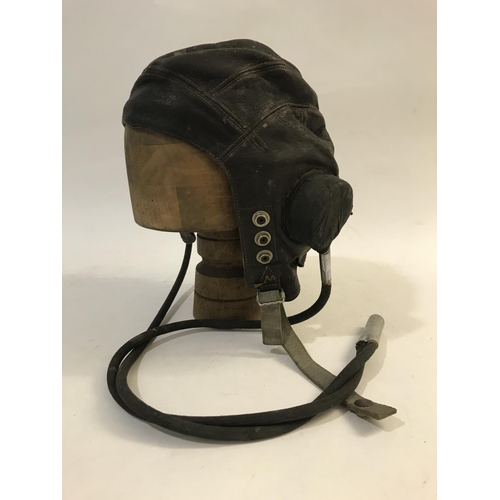 713 - TWO SIMILAR AIR MINISTRY LEATHER FLYING HELMETS AND MOUTHPIECE. A brown leather flying helmet both e... 