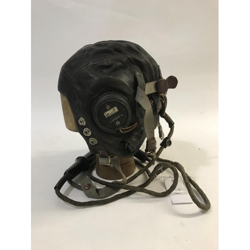 713 - TWO SIMILAR AIR MINISTRY LEATHER FLYING HELMETS AND MOUTHPIECE. A brown leather flying helmet both e... 