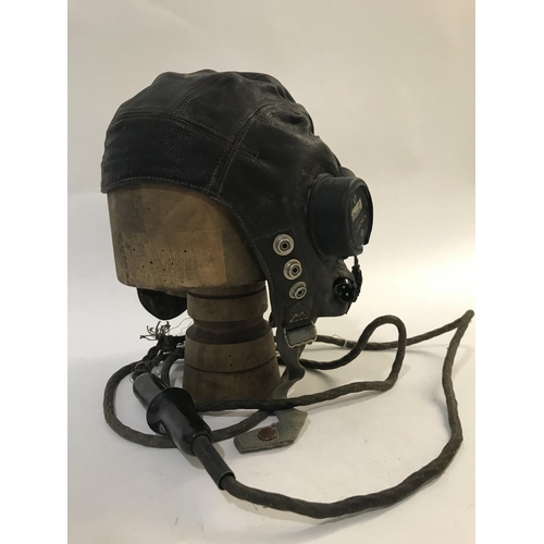 713 - TWO SIMILAR AIR MINISTRY LEATHER FLYING HELMETS AND MOUTHPIECE. A brown leather flying helmet both e... 