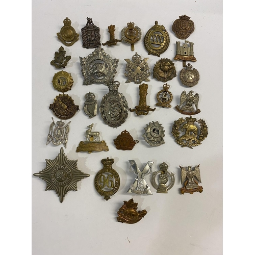 718 - A COLLECTION OF REGIMENTAL CAP BADGES. A collection of thirty cap badges to include examples for the... 