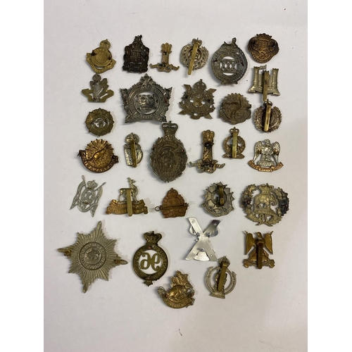 718 - A COLLECTION OF REGIMENTAL CAP BADGES. A collection of thirty cap badges to include examples for the... 