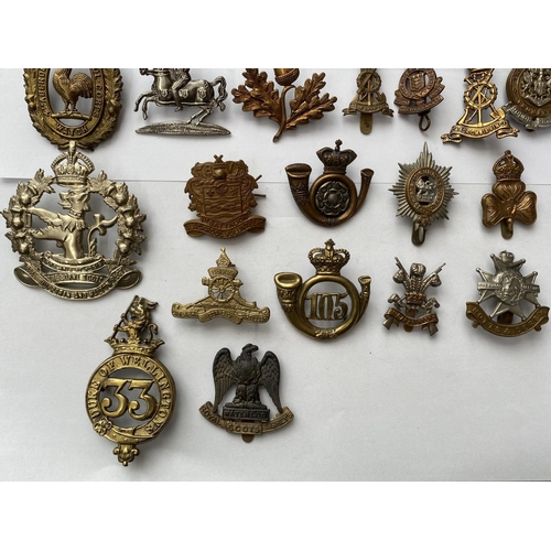 719 - A COLLECTION OF REGIMENTAL CAP BADGES. A collection of thirty cap badges to include examples for the... 