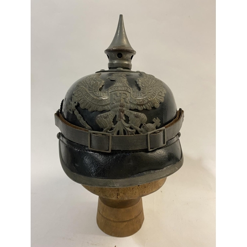 754 - A FIRST WORLD WAR GERMAN PRUSSIAN M-15 PICKELHAUBE. Of domed lacquered black leather with a detachab... 