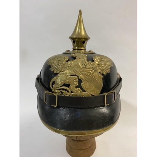 755 - A FIRST WORLD WAR GERMAN BADEN PICKELHAUBE DATED 1915. Of domed lacquered black leather with a short... 