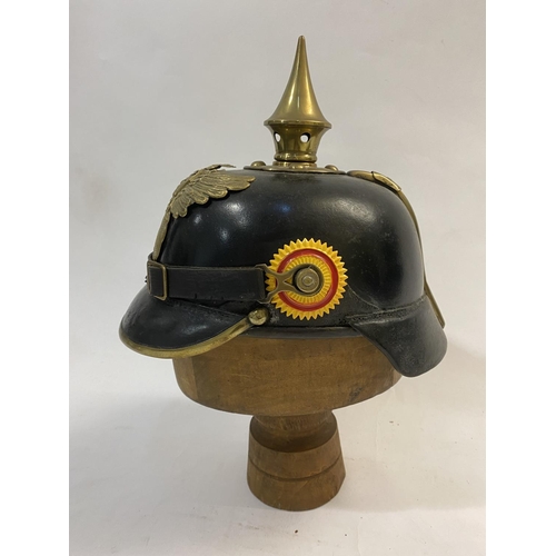 755 - A FIRST WORLD WAR GERMAN BADEN PICKELHAUBE DATED 1915. Of domed lacquered black leather with a short... 