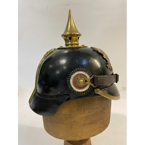 759 - A PRUSSIAN M1915 INFANTRY PICKELHAUBE AND COVER. With a brass spike above five holes on a base plate... 