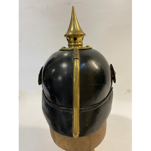 759 - A PRUSSIAN M1915 INFANTRY PICKELHAUBE AND COVER. With a brass spike above five holes on a base plate... 