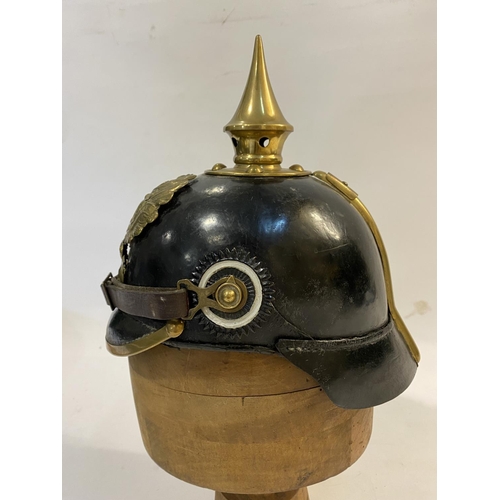 759 - A PRUSSIAN M1915 INFANTRY PICKELHAUBE AND COVER. With a brass spike above five holes on a base plate... 