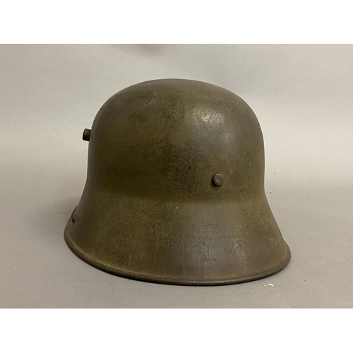 770 - A FIRST WORLD WAR GERMAN M16 PATTERN HELMET. A German steel helmet with pronounced air vents and tur... 