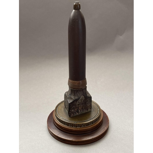 784 - A FIRST WORLD WAR NAVAL SOUVENIR. A desk ornament with central bullet shaped upright on a circular b... 