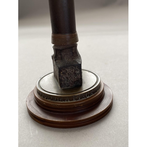 784 - A FIRST WORLD WAR NAVAL SOUVENIR. A desk ornament with central bullet shaped upright on a circular b... 