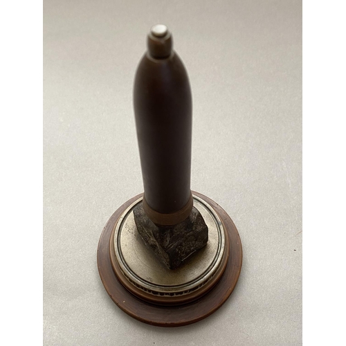 784 - A FIRST WORLD WAR NAVAL SOUVENIR. A desk ornament with central bullet shaped upright on a circular b... 