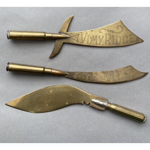 787 - TRENCH ART AND SIMILAR ITEMS. Three trench art letter openers with bullet handles and shaped blades,... 