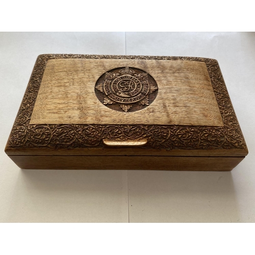 794 - A GEROGE VI R.A.S.C. CARVED WOODEN BOX. A rectangular teak cigarette box with domed lid carved with ... 