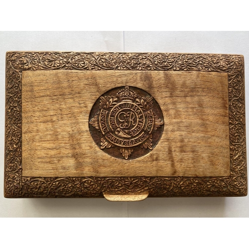 794 - A GEROGE VI R.A.S.C. CARVED WOODEN BOX. A rectangular teak cigarette box with domed lid carved with ... 