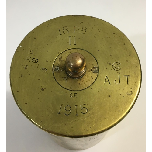 797 - A FIRST WORLD 1915 'TRENCH ART' SHELL CASE. A section of 18 pounder shell casing fitted with a suspe... 