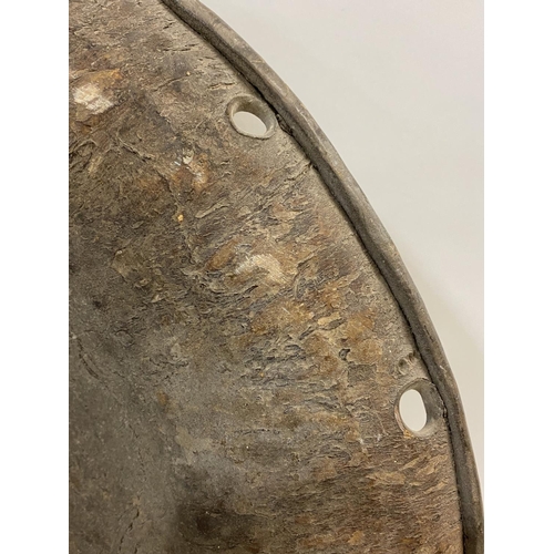 811 - A LARGE CRICULAR SOMALIAN SHIELD. Of thick cow hide with a raised central boss with skin cover, the ... 