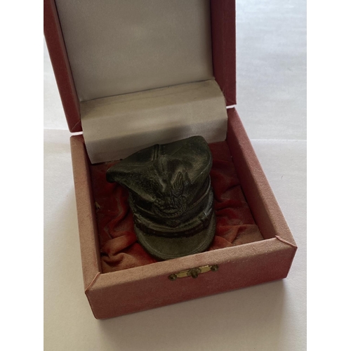 869 - A PRESENTATION PEWTER MODEL OF A SYRIAN MILITARY CAP. In a presentation red box, the hat 5cm high, 8... 