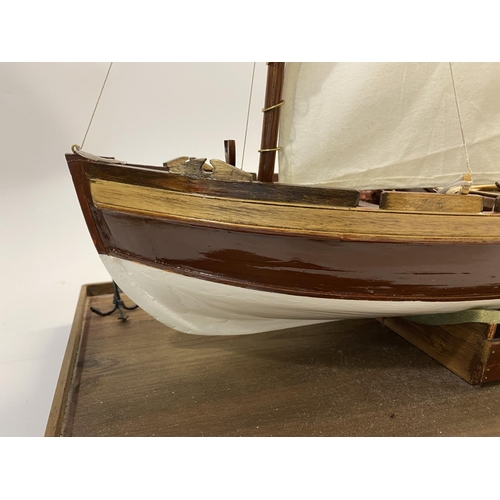 878 - A FINELY BUILT MODEL OF H.M.S. VICOTRY'S ANCHOR SLOOP. A well detailed model of a single masted sloo... 