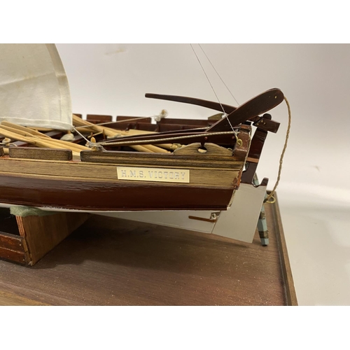 878 - A FINELY BUILT MODEL OF H.M.S. VICOTRY'S ANCHOR SLOOP. A well detailed model of a single masted sloo... 