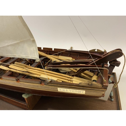 878 - A FINELY BUILT MODEL OF H.M.S. VICOTRY'S ANCHOR SLOOP. A well detailed model of a single masted sloo... 