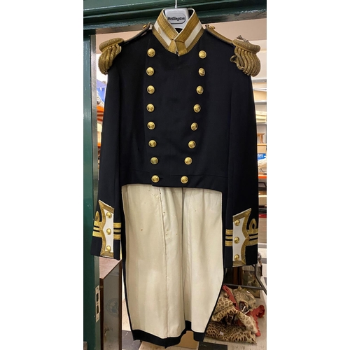 893 - AN EARLY 20TH CENTURY LIEUTENANT COMMANDERS TAIL COAT. A double breasted tail coat with 16 button fr... 