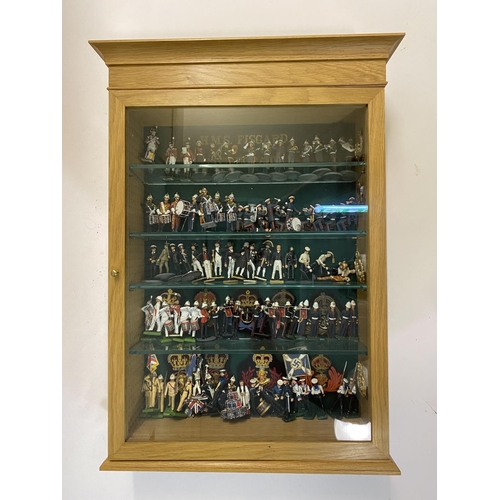 901 - A LARGE COLLECTION OF HAND PAINTED MILITARY FIGURES. A glass fronted oak effect display cabinet cont... 