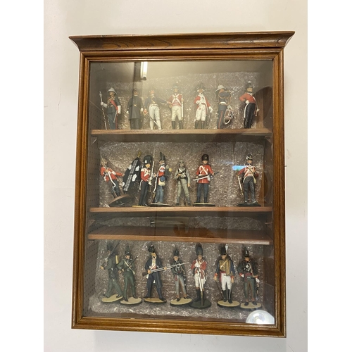 901 - A LARGE COLLECTION OF HAND PAINTED MILITARY FIGURES. A glass fronted oak effect display cabinet cont... 