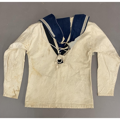 902 - TWO WHITE SAILORS SMOCKS WITH BLUE COLLARS. Two similar white sailors smocks, both with blue collars... 