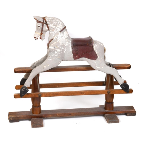 1367 - ANTIQUE ROCKING HORSE a painted rocking horse mounted on a wooden trestle stand, fitted with a saddl... 