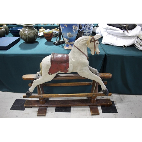 1367 - ANTIQUE ROCKING HORSE a painted rocking horse mounted on a wooden trestle stand, fitted with a saddl... 